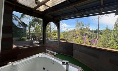a bath tub in a room with a large window at PrivaDome in Rionegro