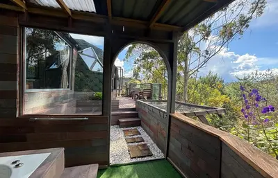 an outside view of a bathroom with a tub and a window at PrivaDome in Rionegro