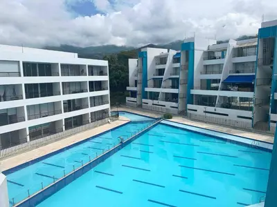a large swimming pool in front of two buildings at Edén de Alejo - Apartamento - Lujo y Confort en San Jerónimo in San Jerónimo