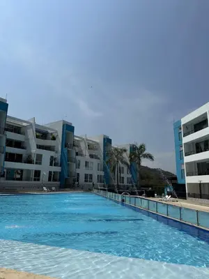 a large swimming pool in front of some buildings at Edén de Alejo - Apartamento - Lujo y Confort en San Jerónimo in San Jerónimo