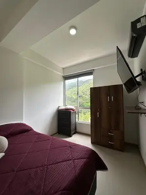 a bedroom with a purple bed and a window at Edén de Alejo - Apartamento - Lujo y Confort en San Jerónimo in San Jerónimo