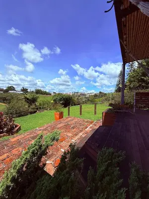 a brick patio with a view of a field at San José de las bromelias in Marinilla