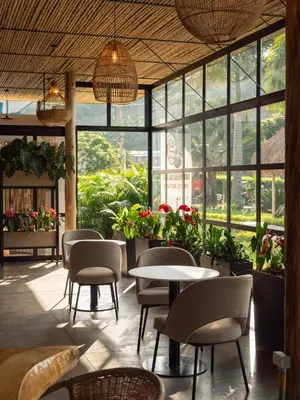 a restaurant with tables and chairs and windows at Atardeceres del Cafe in Manizales
