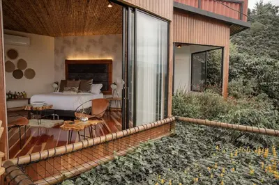 a bedroom in a house with a bed and a patio at Atardeceres del Cafe in Manizales