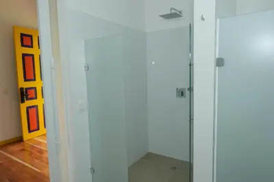 a glass shower stall in a room with at Atardeceres del Cafe in Manizales