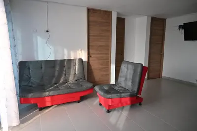 two chairs sitting next to each other in a room at Travelu Guatape Apartamento in Guatapé