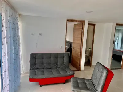 a living room with a couch and a chair at Travelu Guatape Apartamento in Guatapé