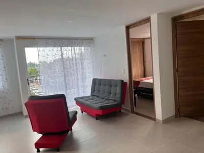 a living room with a couch and a chair at Travelu Guatape Apartamento in Guatapé
