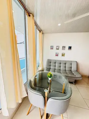 a living room with a glass table and a couch at TORRES DEL MESÓN LUXURY APARTA HOTEL Doradal in Doradal