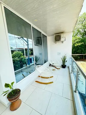 two chairs and tables on a balcony with windows at TORRES DEL MESÓN LUXURY APARTA HOTEL Doradal in Doradal
