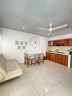 a living room with a table and a clock on the wall at TORRES DEL MESÓN LUXURY APARTA HOTEL Doradal in Doradal