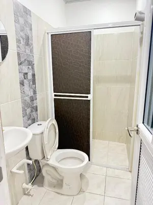 a bathroom with a toilet and a sink and a shower at TORRES DEL MESÓN LUXURY APARTA HOTEL Doradal in Doradal