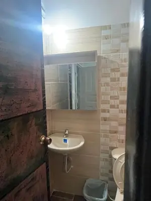 a bathroom with a sink and a toilet and a mirror at Hotel RIO Y SOL DORADO in La Dorada