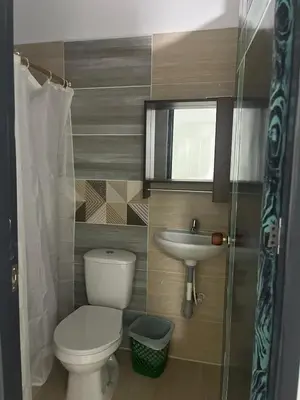 a small bathroom with a toilet and a sink at Hotel RIO Y SOL DORADO in La Dorada