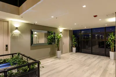 an empty lobby with potted plants in a building at 4 Sur Hotel in Medellín