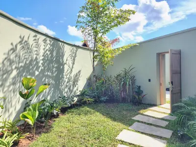 a white house with a garden and a pathway at Hotel Piedra Mulata - Adults Only in Doradal