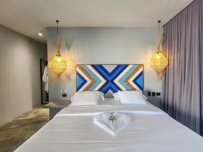 a bedroom with a white bed with a heart on it at Hotel Piedra Mulata - Adults Only in Doradal