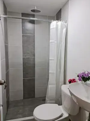 a bathroom with a shower and a toilet and a sink at PRIMAVERA LIVING in Medellín