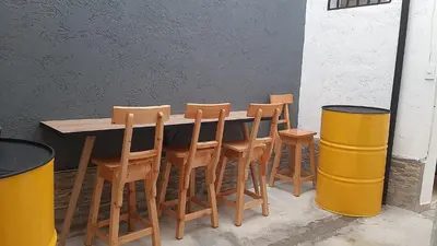 a wooden table with four wooden chairs and a counter at PRIMAVERA LIVING in Medellín