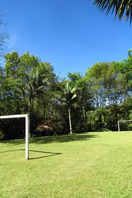 a soccer goal in a field with palm trees at CASA DE CAMPO VILLA OLI!! - Un paraiso natural en la ciudad in Villamaría