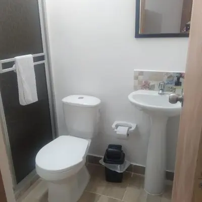 a white bathroom with a toilet and a sink at Casa Hotel Castellón in Hispania