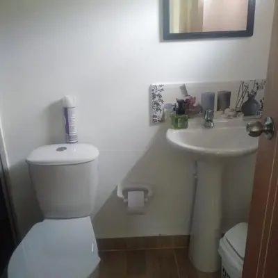a bathroom with a toilet and a sink at Casa Hotel Castellón in Hispania