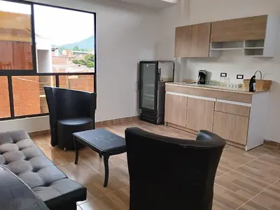 a kitchen with a couch and chairs in a room at Casa Hotel Castellón in Hispania