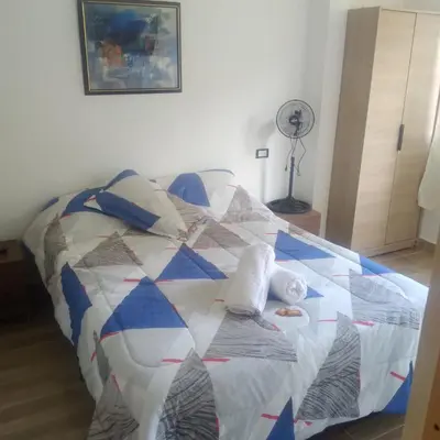 a bed with a quilt on it in a room at Casa Hotel Castellón in Hispania