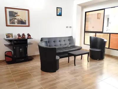 a living room with a black couch and chairs at Casa Hotel Castellón in Hispania