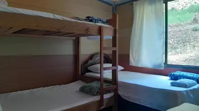 two bunk beds in a room with a window at Cabaña La Guitarra in Betania