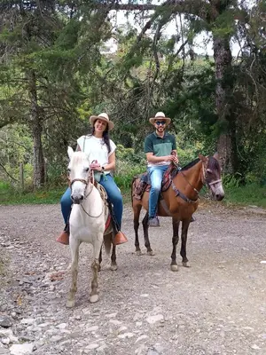 two people riding horses on a dirt road at Cabaña Momotus I in Concepción