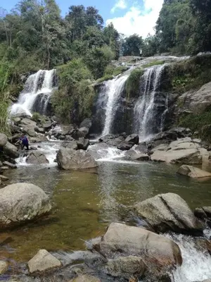 a waterfall in the middle of a river with rocks at Cabaña Momotus I in Concepción