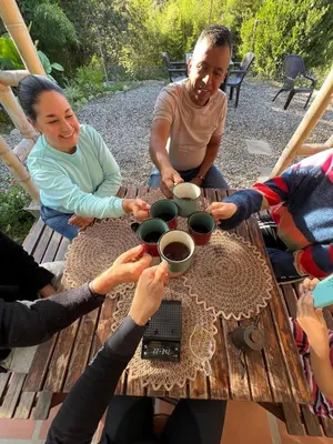 a group of people sitting around a table at Cabaña Momotus I in Concepción