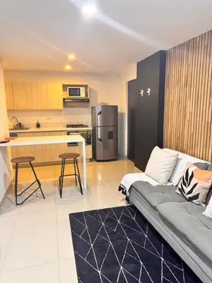 a living room with a couch and a kitchen at 1208 Beautiful apartment, exclusive area in the poblado in Medellín
