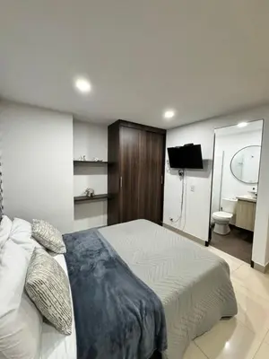 a bedroom with a bed and a bathroom with a toilet at 1208 Beautiful apartment, exclusive area in the poblado in Medellín
