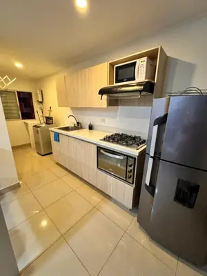 a kitchen with a refrigerator and a stove top oven at 1208 Beautiful apartment, exclusive area in the poblado in Medellín