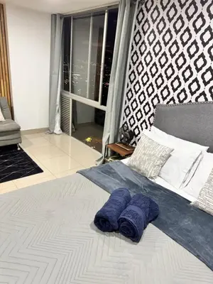 a bed with two blue pillows on top of it at 1208 Beautiful apartment, exclusive area in the poblado in Medellín