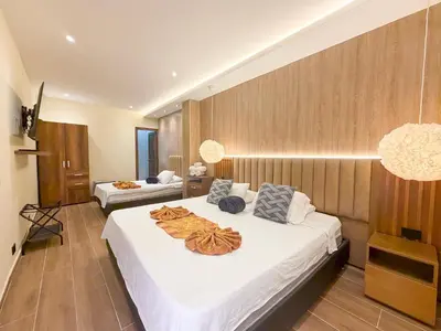 a hotel room with two beds with white sheets at Hotel Recuerdos de mi Tierra El Poblado Provenza in Medellín