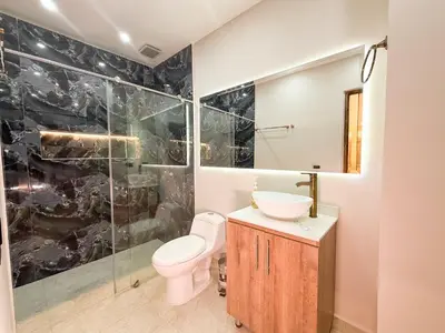 a bathroom with a toilet and a sink and a shower at Hotel Recuerdos de mi Tierra El Poblado Provenza in Medellín