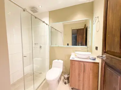 a bathroom with a toilet and a sink and a shower at Hotel Recuerdos de mi Tierra El Poblado Provenza in Medellín