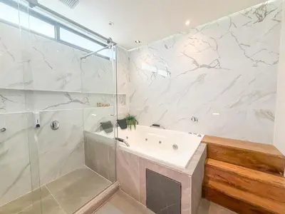 a bathroom with a shower and a tub and a sink at Hotel Recuerdos de mi Tierra El Poblado Provenza in Medellín