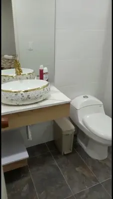 a bathroom with a white toilet and a sink at Hermoso apartamento Medellín in Medellín