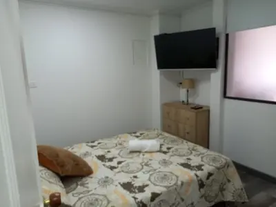 a bedroom with a bed and a flat screen tv at Hermoso apartamento Medellín in Medellín
