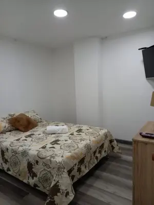 a bedroom with a bed with a blanket on it at Hermoso apartamento Medellín in Medellín