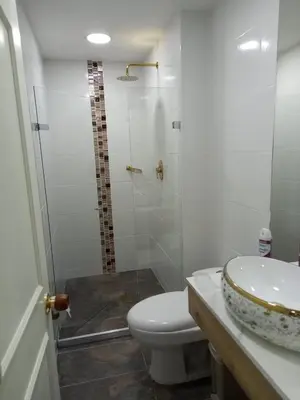 a bathroom with a toilet and a sink and a shower at Hermoso apartamento Medellín in Medellín