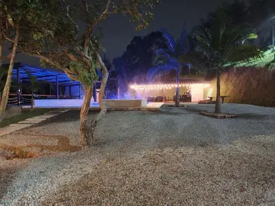 a building with a tree in front of it at night at La escondida in Guarne