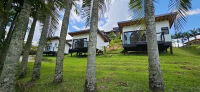 a resort with palm trees in front of it at La escondida in Guarne