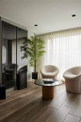 a living room with two chairs and a table at Hotel Selis in Medellín