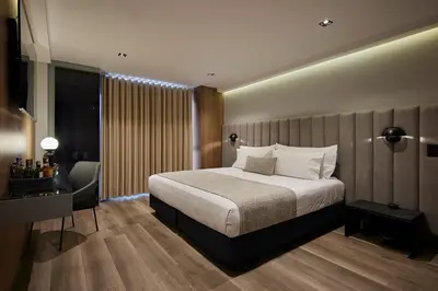 a hotel room with a bed and a desk at Hotel Selis in Medellín
