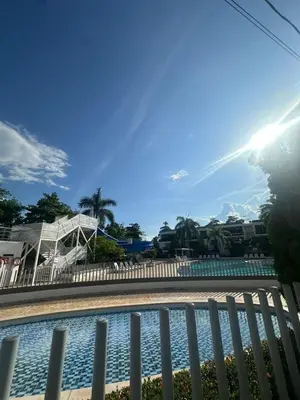 a view of a swimming pool with a fence at Apartasol privado Santa Fe de Antioquia in Santa Fe de Antioquia